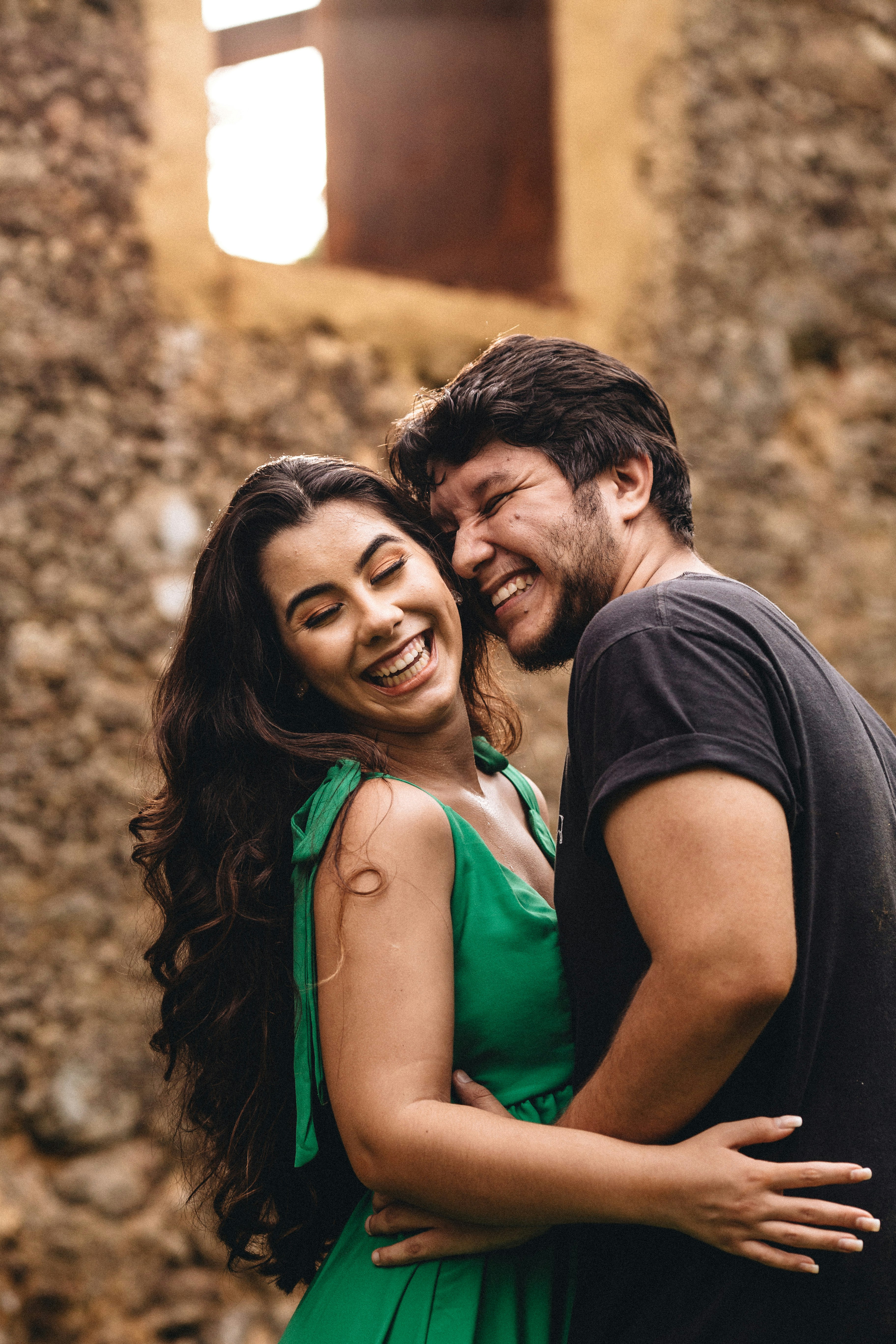 man in black crew neck shirt beside woman in green tank top